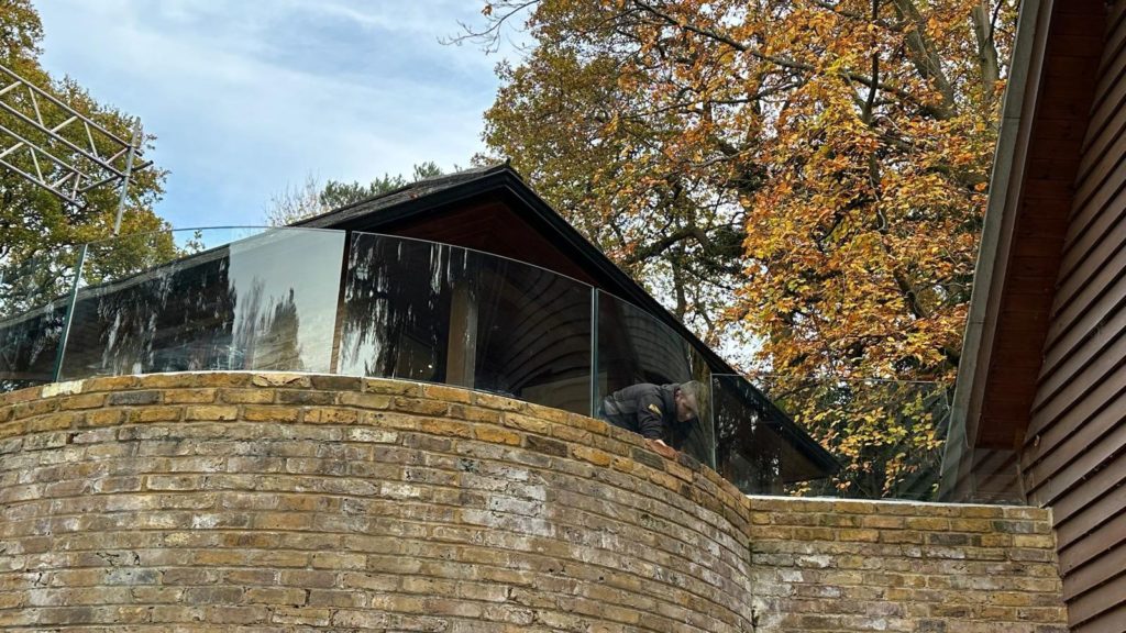 Curved glass balustrade overlooking garden Curved glass balustrades